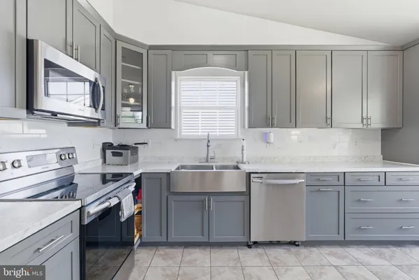 a kitchen with a sink stove and cabinets