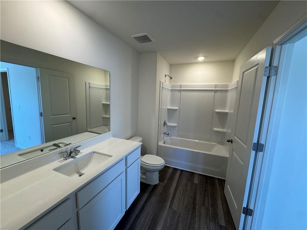 423 Towson Street Villa Rica, GA 30180 - Photo 13 of 19 a bathroom with a sink a toilet a mirror and shower