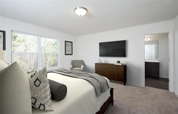 a bedroom with a bed and a flat screen tv