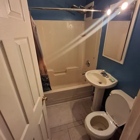 a bathroom with a toilet a sink and a mirror