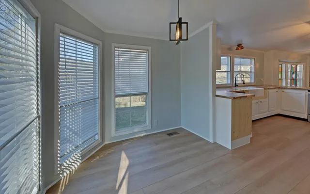 a view of a kitchen cabinets and wooden floor