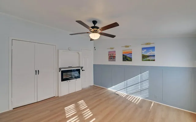 a bedroom with furniture and a ceiling fan