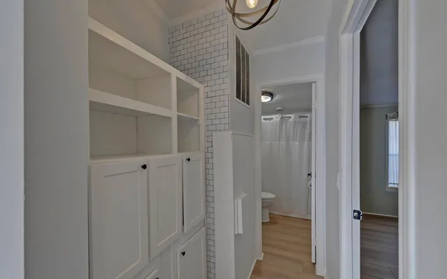 a view of a bathroom from a hallway