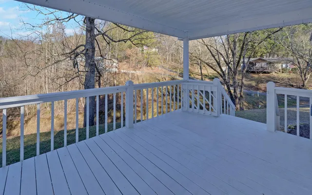 a balcony with wooden floor and fence