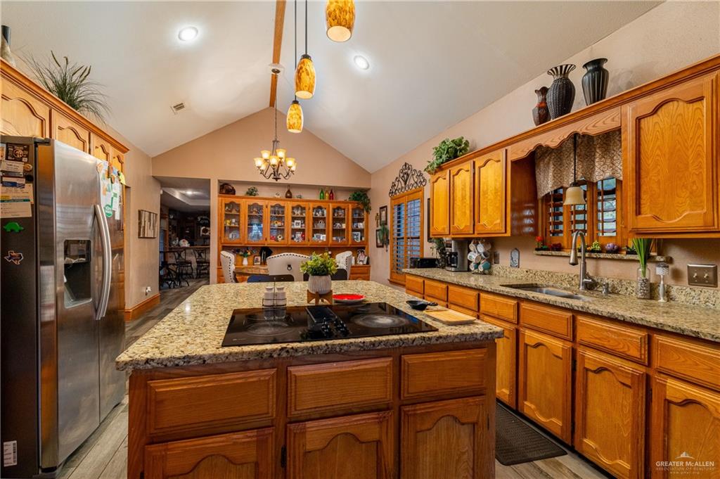 4113 North Fm 493 Road Donna, TX 78537 - Photo 11 of 18 a kitchen with stainless steel appliances granite countertop a sink a stove and a refrigerator