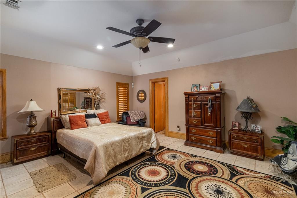 4113 North Fm 493 Road Donna, TX 78537 - Photo 15 of 18 a bedroom with bed and a chandelier