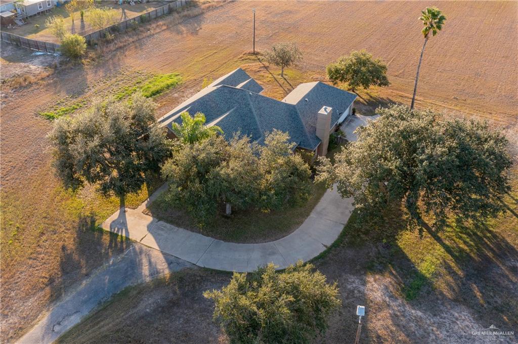 4113 North Fm 493 Road Donna, TX 78537 - Photo 4 of 18 an aerial view of a house with a yard and trees