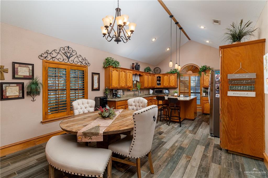 4113 North Fm 493 Road Donna, TX 78537 - Photo 10 of 18 a living room with furniture a chandelier and a dining table