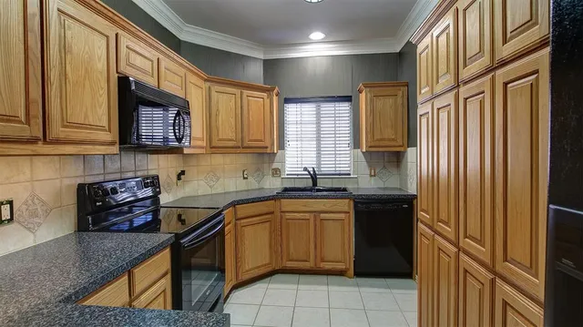 a kitchen with a sink stove and cabinets