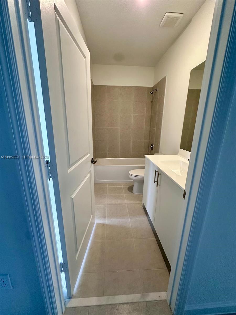 35702 Southwest 178th Court, Unit 35702 Homestead, FL 33034 - Photo 11 of 38 a view of a hallway with washer and dryer