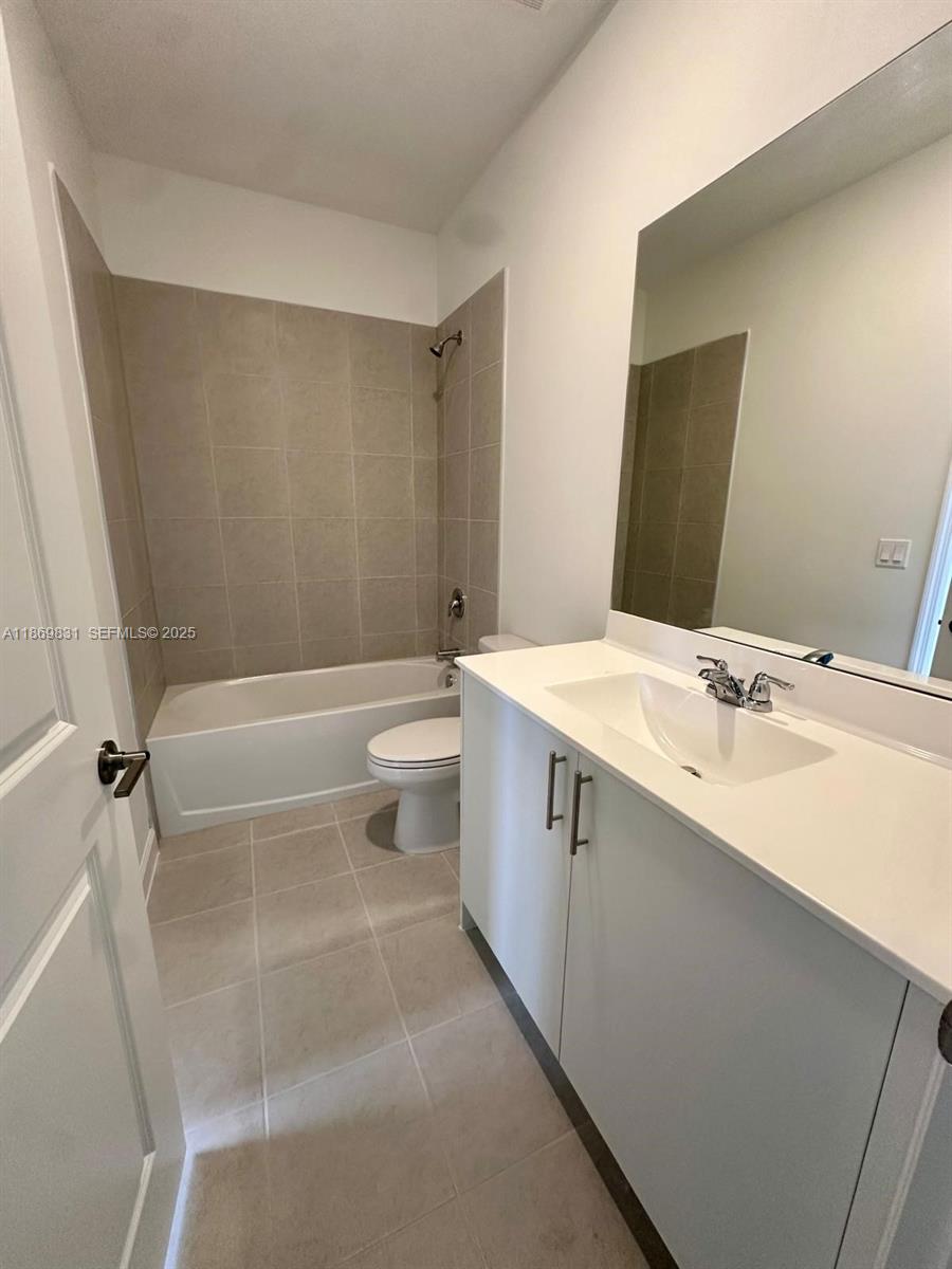 35702 Southwest 178th Court, Unit 35702 Homestead, FL 33034 - Photo 12 of 38 a bathroom with a sink a toilet and shower