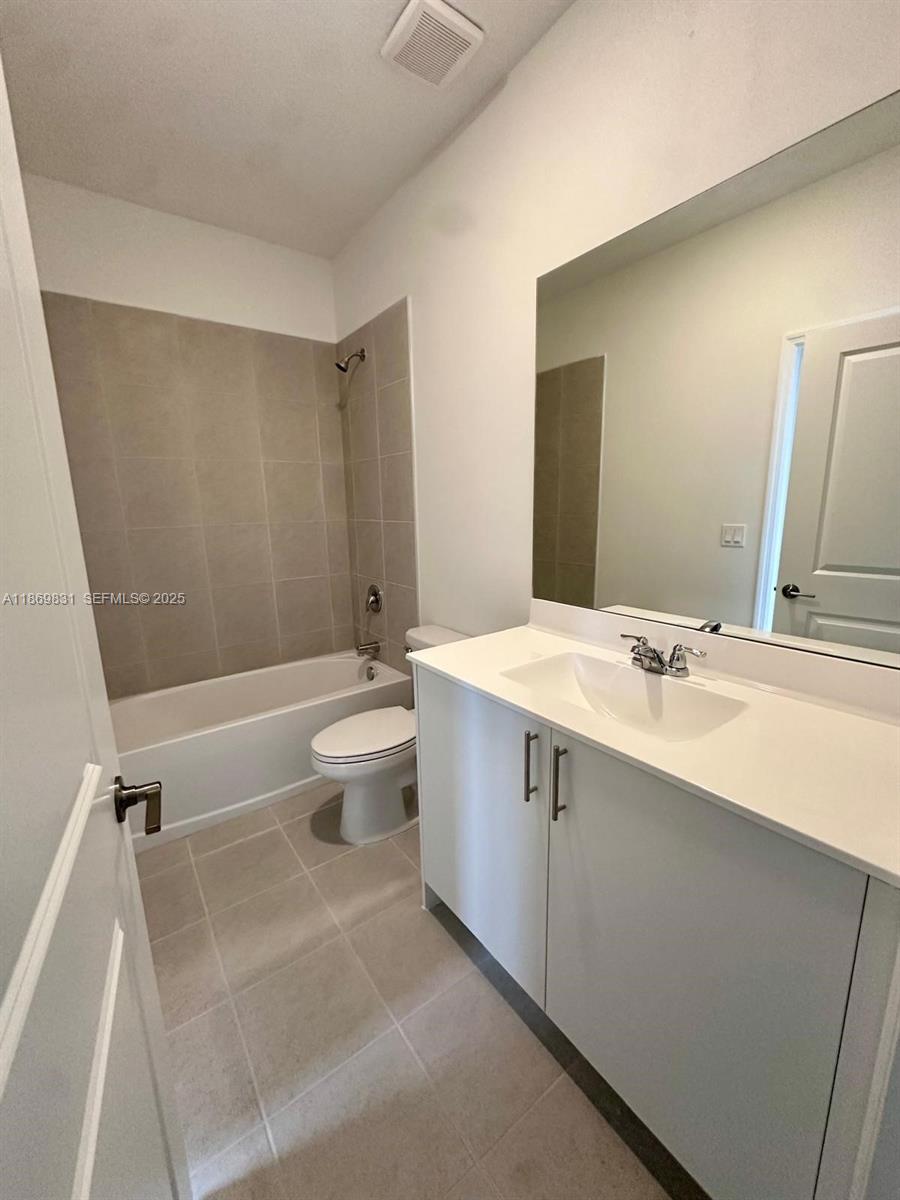 35702 Southwest 178th Court, Unit 35702 Homestead, FL 33034 - Photo 13 of 38 a spacious bathroom with a double vanity sink toilet mirror and a tub