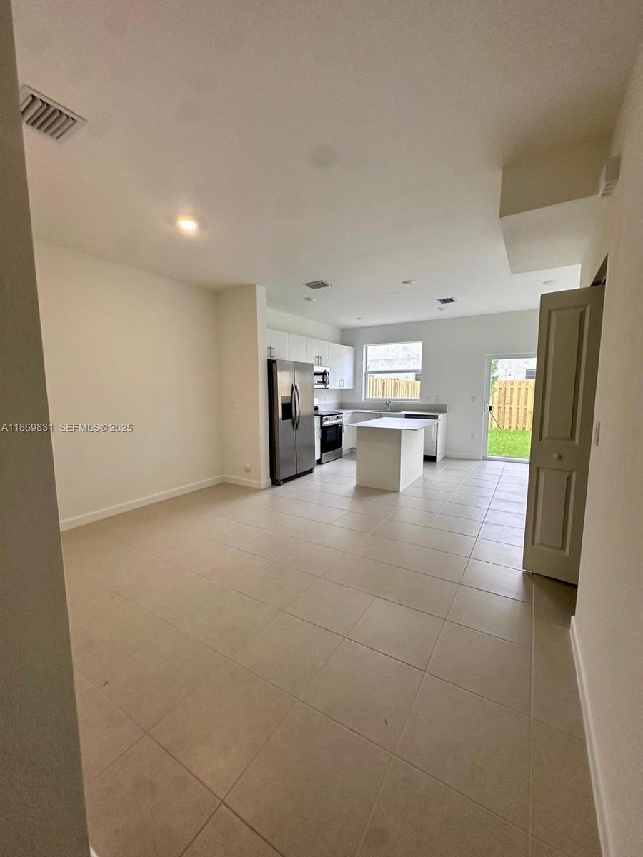 35702 Southwest 178th Court, Unit 35702 Homestead, FL 33034 - Photo 14 of 38 a view of kitchen with refrigerator stove and cabinets