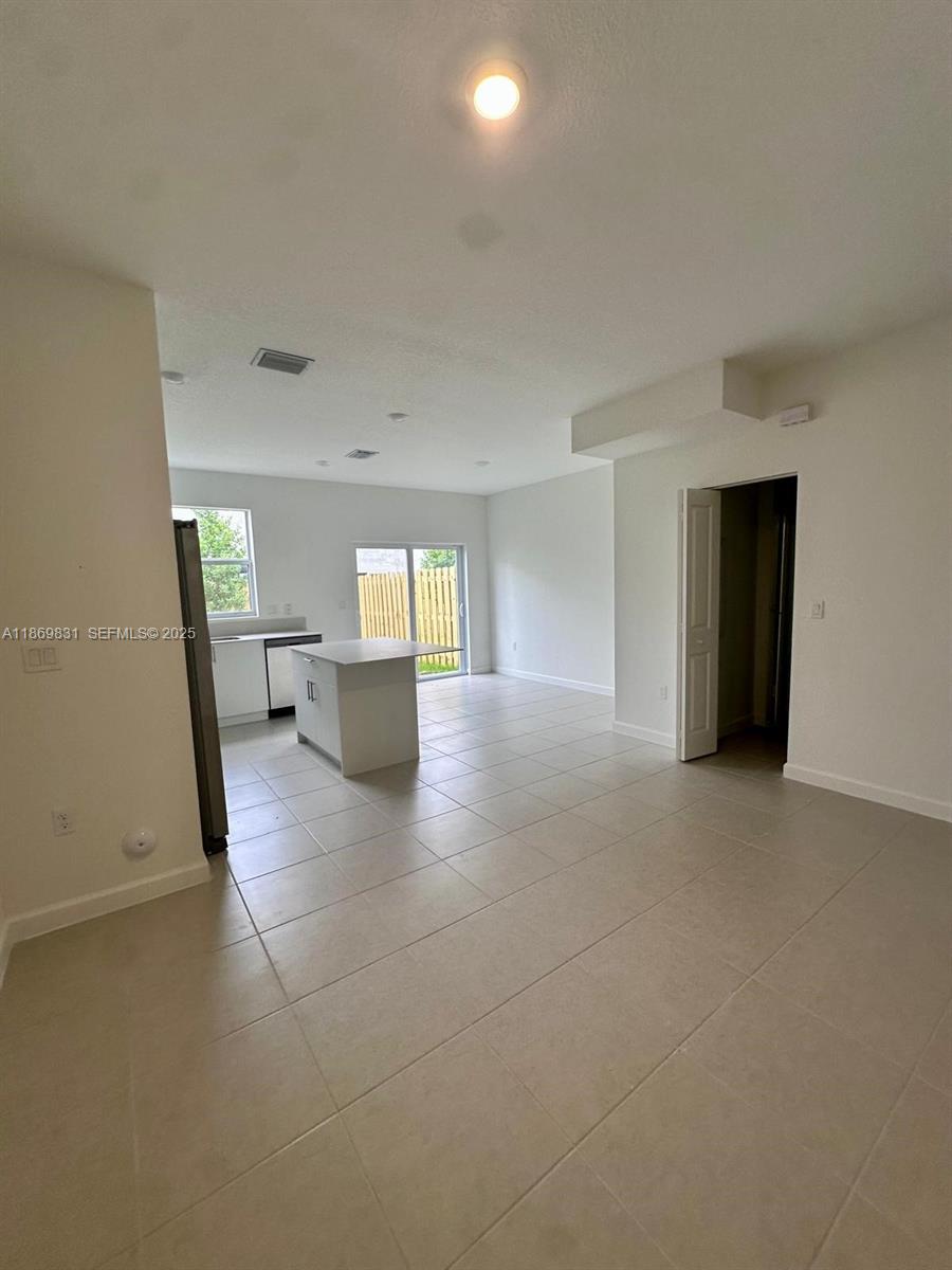35702 Southwest 178th Court, Unit 35702 Homestead, FL 33034 - Photo 15 of 38 a view of empty room with wooden floor
