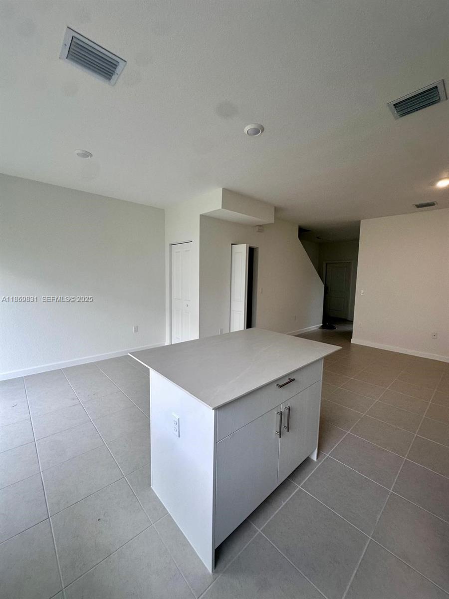 35702 Southwest 178th Court, Unit 35702 Homestead, FL 33034 - Photo 21 of 38 a kitchen with a stove and cabinets