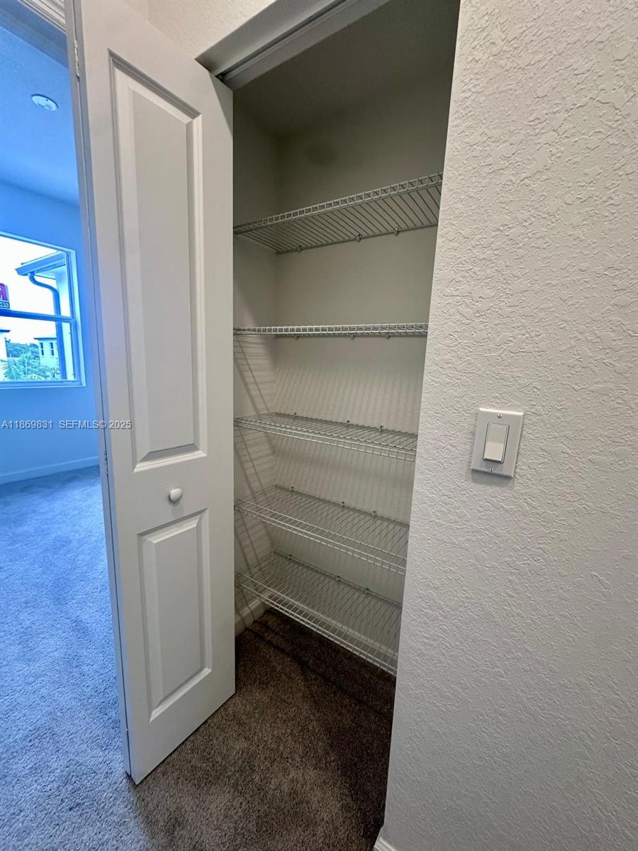 35702 Southwest 178th Court, Unit 35702 Homestead, FL 33034 - Photo 27 of 38 a view of walk in closet