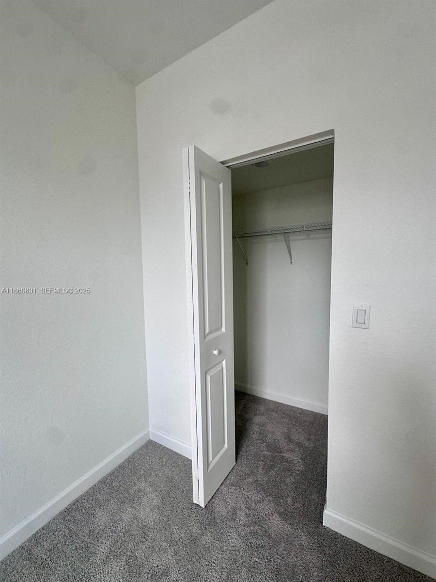 35702 Southwest 178th Court, Unit 35702 Homestead, FL 33034 - Photo 29 of 38 an empty room with closet