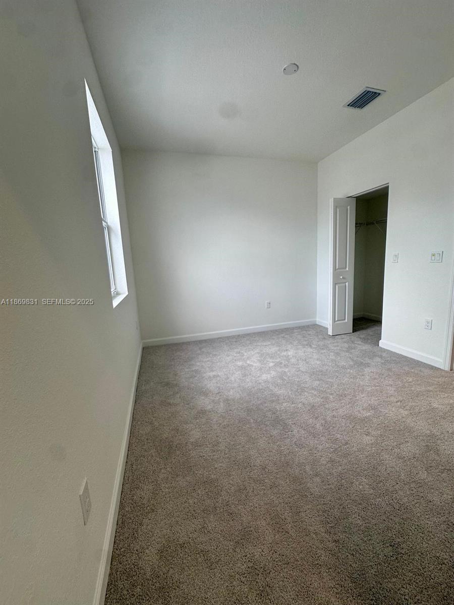 35702 Southwest 178th Court, Unit 35702 Homestead, FL 33034 - Photo 33 of 38 an empty room with a natural light