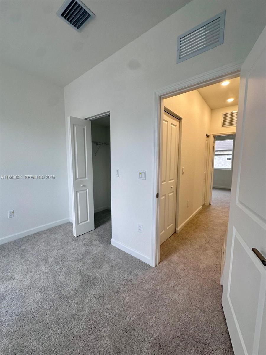 35702 Southwest 178th Court, Unit 35702 Homestead, FL 33034 - Photo 34 of 38 an empty room with windows and closet