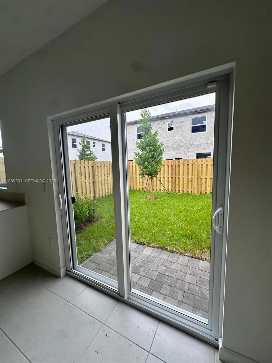 35702 Southwest 178th Court, Unit 35702 Homestead, FL 33034 - Photo 35 of 38 a view of a porch and garden