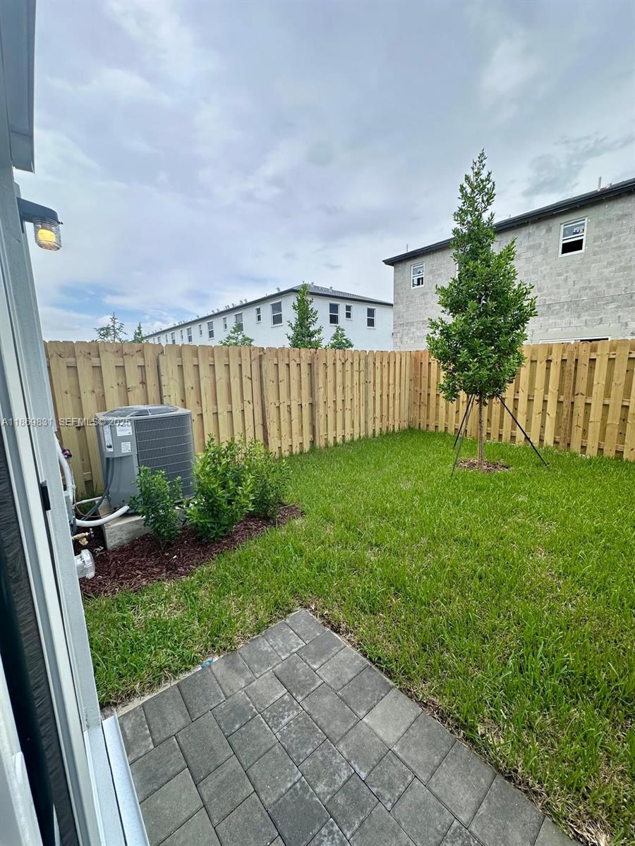 35702 Southwest 178th Court, Unit 35702 Homestead, FL 33034 - Photo 36 of 38 a backyard of a house with lots of green space and plants