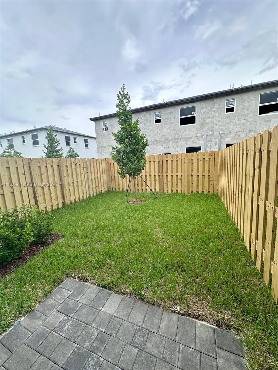35702 Southwest 178th Court, Unit 35702 Homestead, FL 33034 - Photo 37 of 38 a backyard of a house with lots of green space