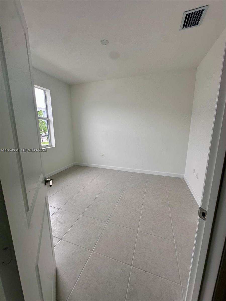 35702 Southwest 178th Court, Unit 35702 Homestead, FL 33034 - Photo 8 of 38 an empty room with windows