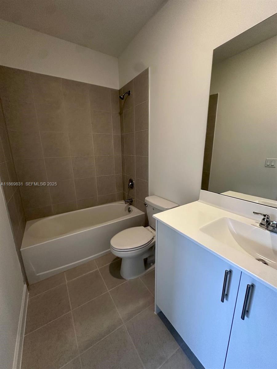 35702 Southwest 178th Court, Unit 35702 Homestead, FL 33034 - Photo 9 of 38 a bathroom with a sink a toilet and a bathtub