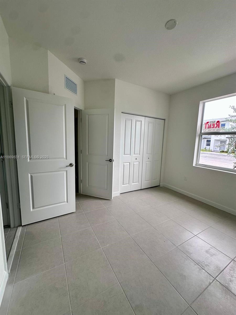 35702 Southwest 178th Court, Unit 35702 Homestead, FL 33034 - Photo 10 of 38 a view of an empty room with a window