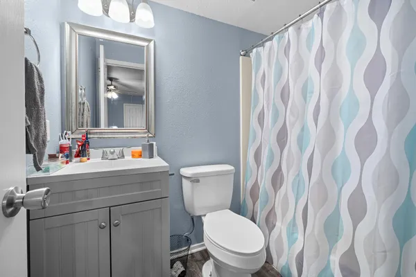 a bathroom with a toilet sink and mirror