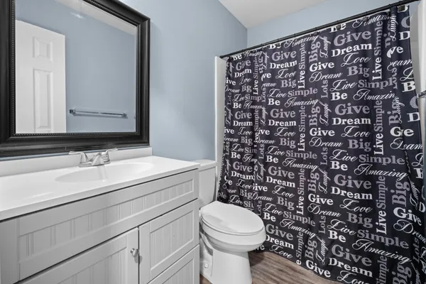 a bathroom with a sink toilet and mirror