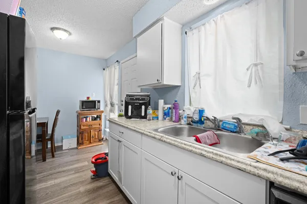 a kitchen with sink cabinets and appliances