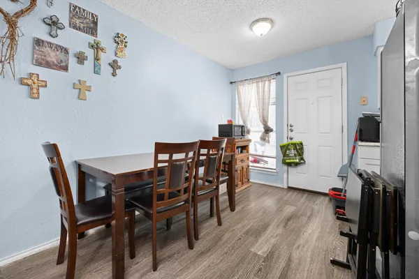 a view of a dining room with furniture and wooden floor