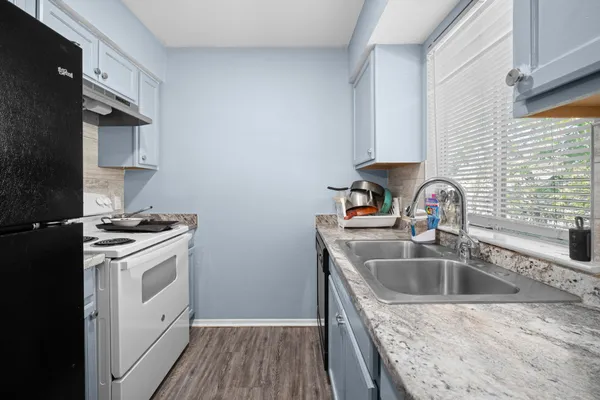 a kitchen that has a sink and a stove