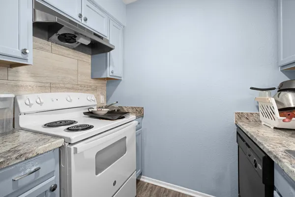 a white stove top oven sitting inside of a kitchen