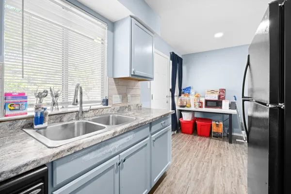 a kitchen with sink cabinets and appliances