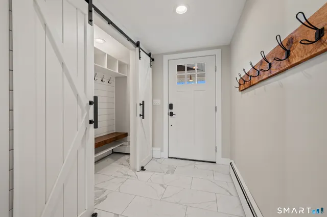 a view of an entryway with wooden floor