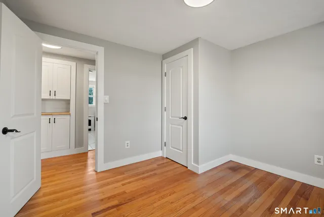 a view of an empty room and wooden floor
