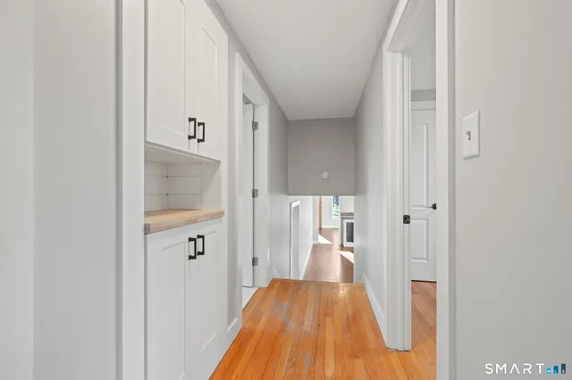 a view of hallway with wooden floor