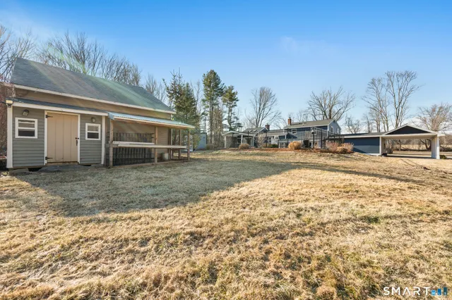 a view of a yard with a house in the background
