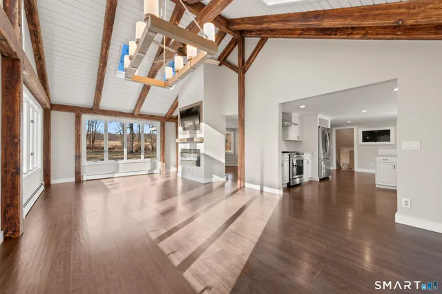 a view of interior space with wooden floor and outer view
