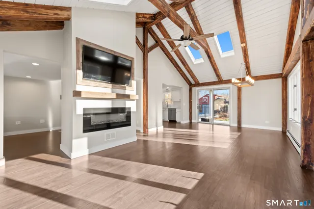 a view of an entryway and hall with wooden floor