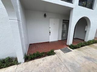 18206 Mediterranean Boulevard, Unit 421 Hialeah, FL 33015 - Photo 1 of 22 a front view of a house with garden
