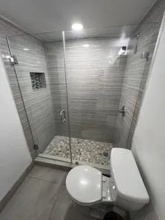 a bathroom with a sink a toilet and mirror