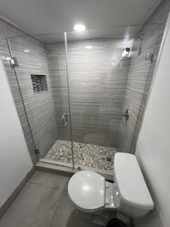 18206 Mediterranean Boulevard, Unit 421 Hialeah, FL 33015 - Photo 11 of 22 a bathroom with a sink toilet and shower