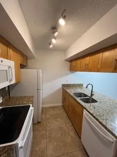 a kitchen that has a sink and a stove