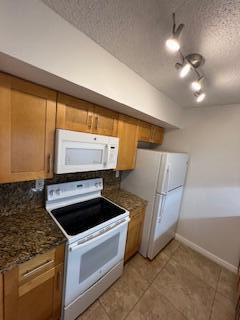 18206 Mediterranean Boulevard, Unit 421 Hialeah, FL 33015 - Photo 14 of 22 a kitchen that has a sink and a stove
