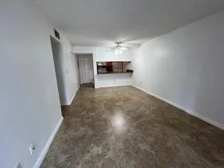 a view of empty room with a ceiling fan