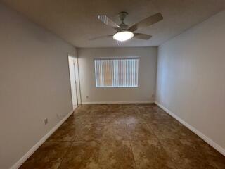 18206 Mediterranean Boulevard, Unit 421 Hialeah, FL 33015 - Photo 7 of 22 an empty room with windows and fan