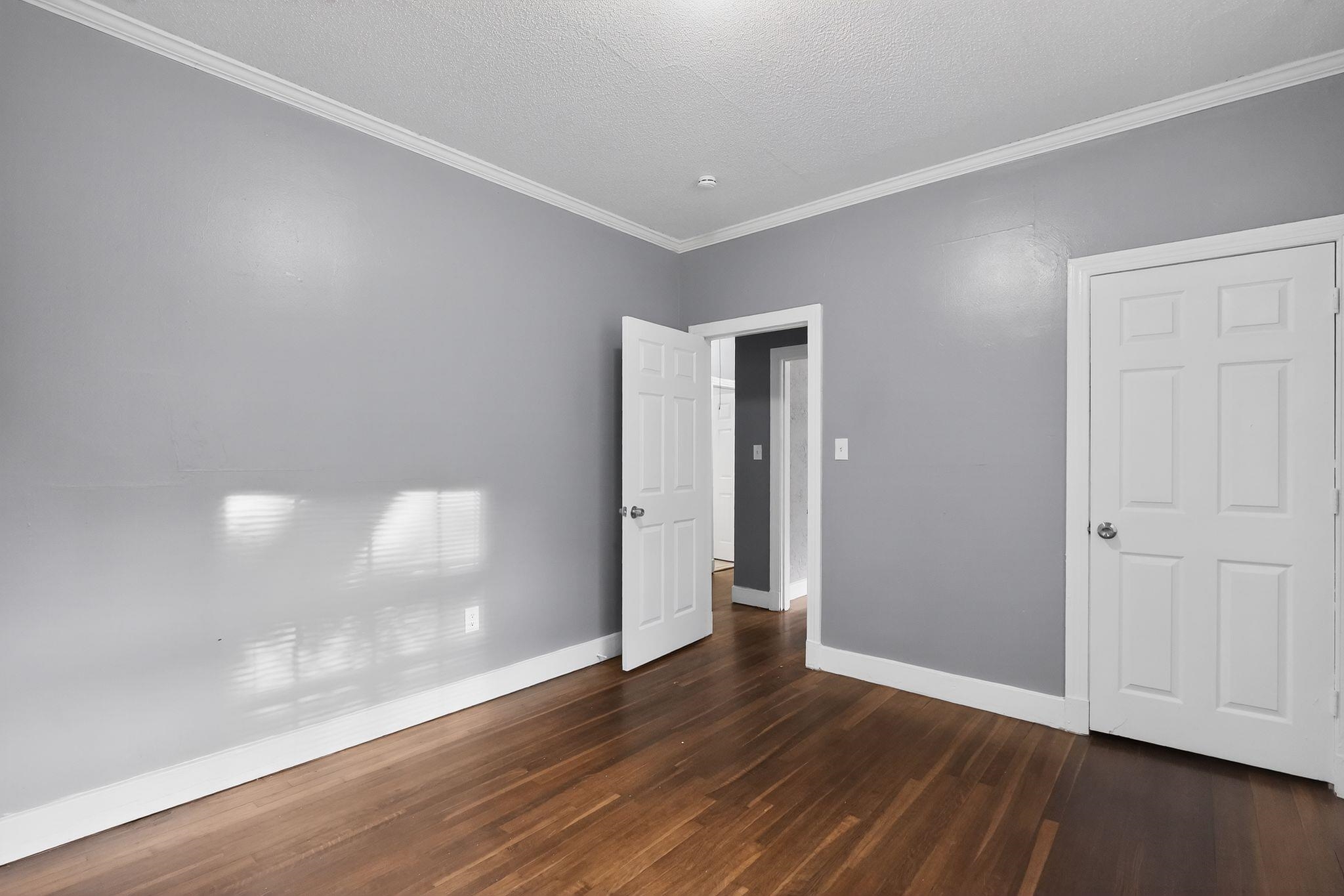 4199 Auburn Road Memphis, TN 38116 - Photo 24 of 32 Interior room featuring wood-finish flooring, light gray walls, and white crown molding